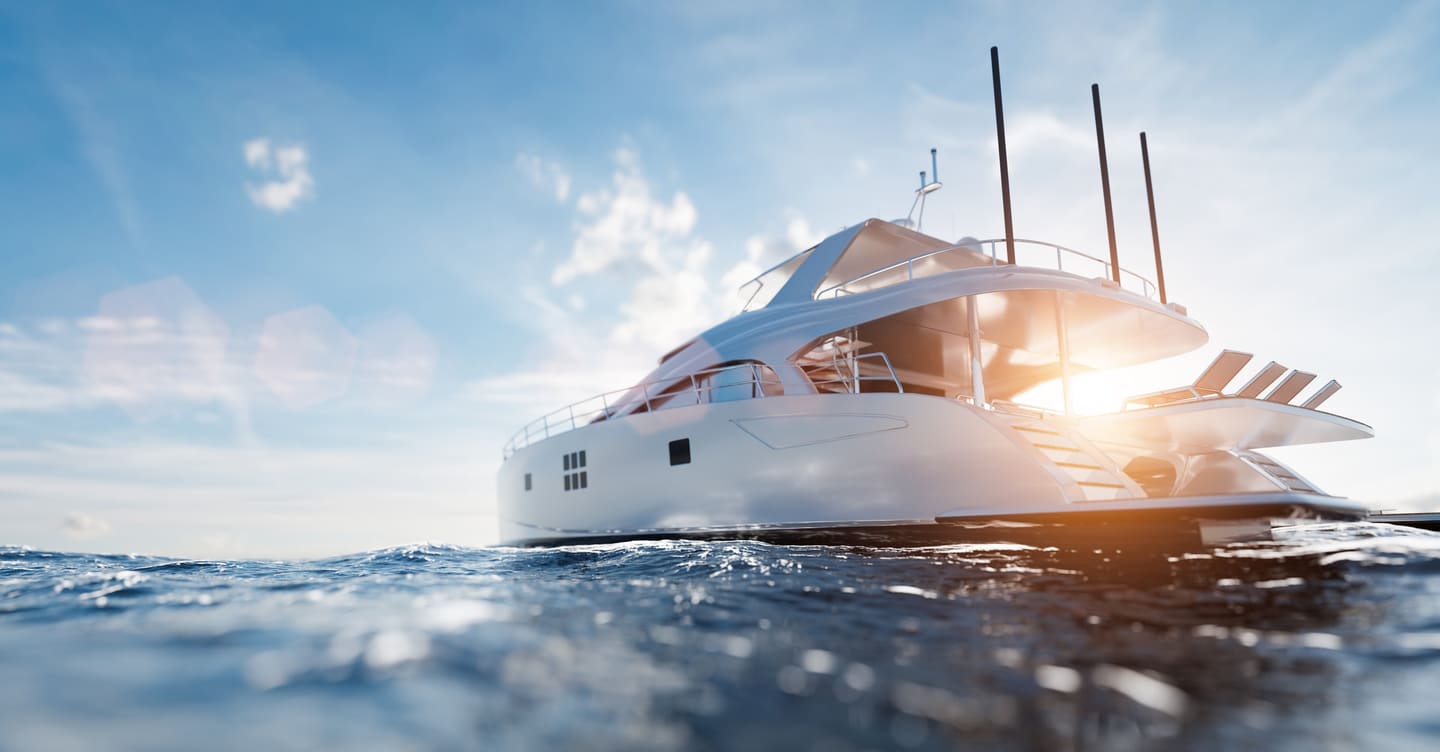 A white motor yacht cruising calm Mediterranean water under a bright sky